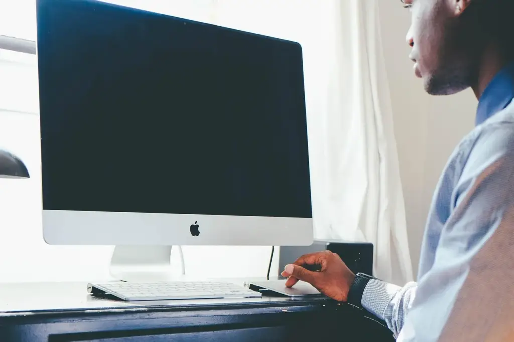 A person typing on a laptop at a desk, illustrating content optimization work using Search Console